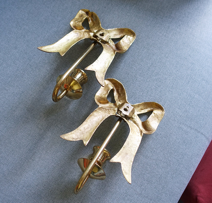Pair of Hollywood Regency brass bow candle sconces