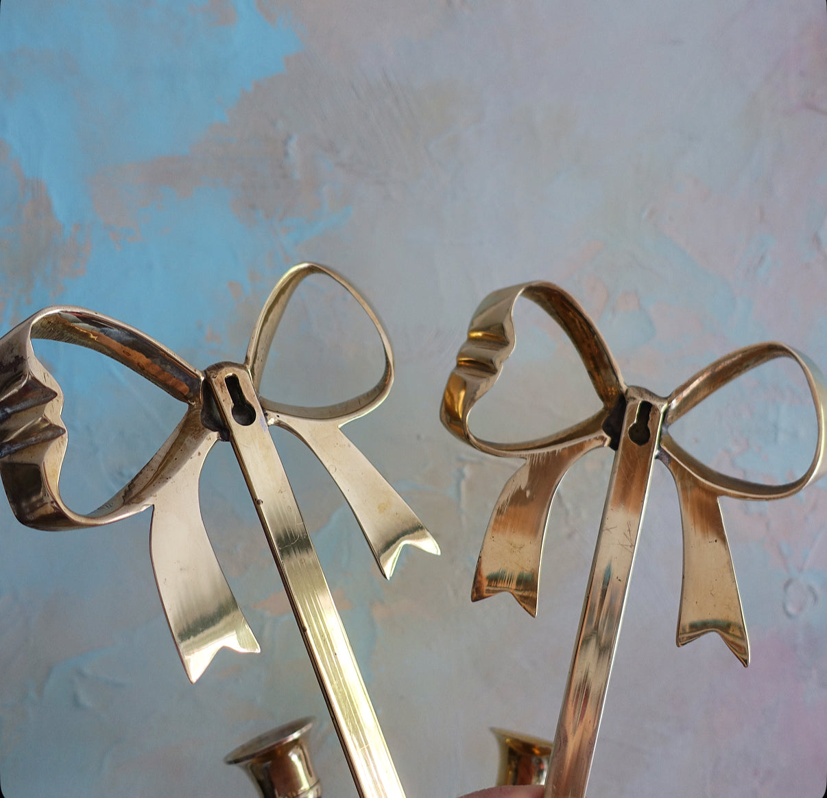 Pair of brass bow candle sconces