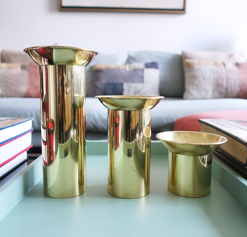 Set of three brass pillar candle holders