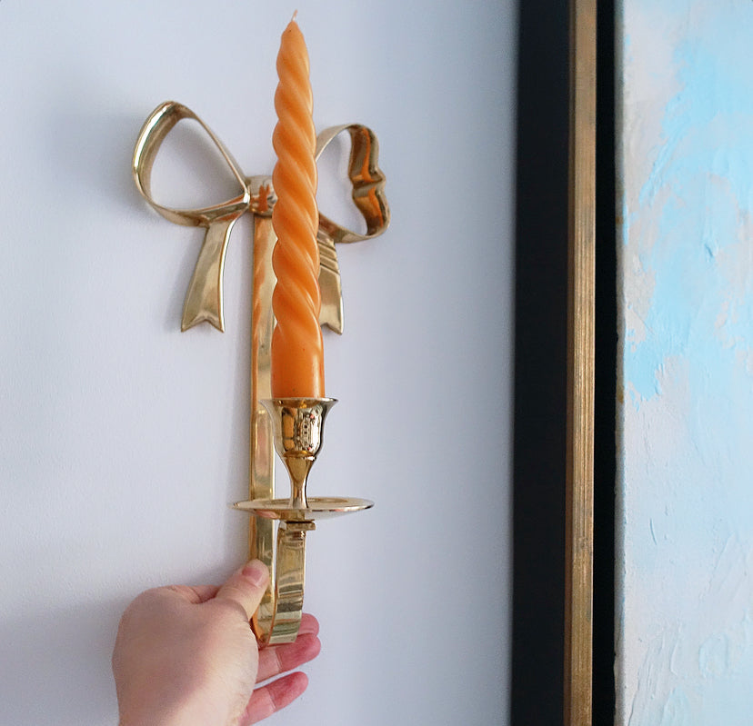 Pair of Hollywood Regency brass bow candle sconces