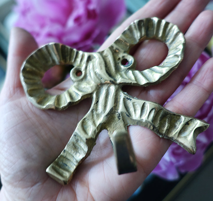 Set of three brass bow hooks