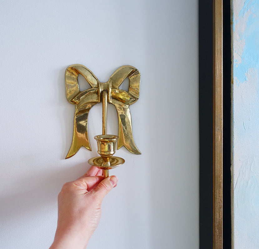 Pair of Hollywood Regency brass bow candle sconces