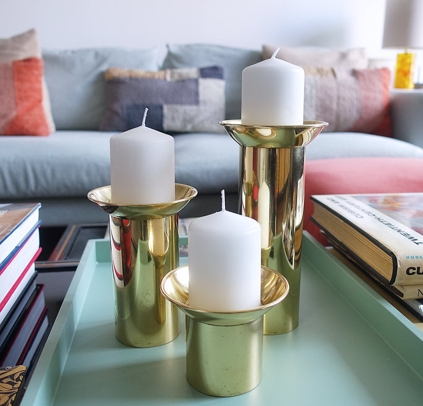 Set of three brass pillar candle holders