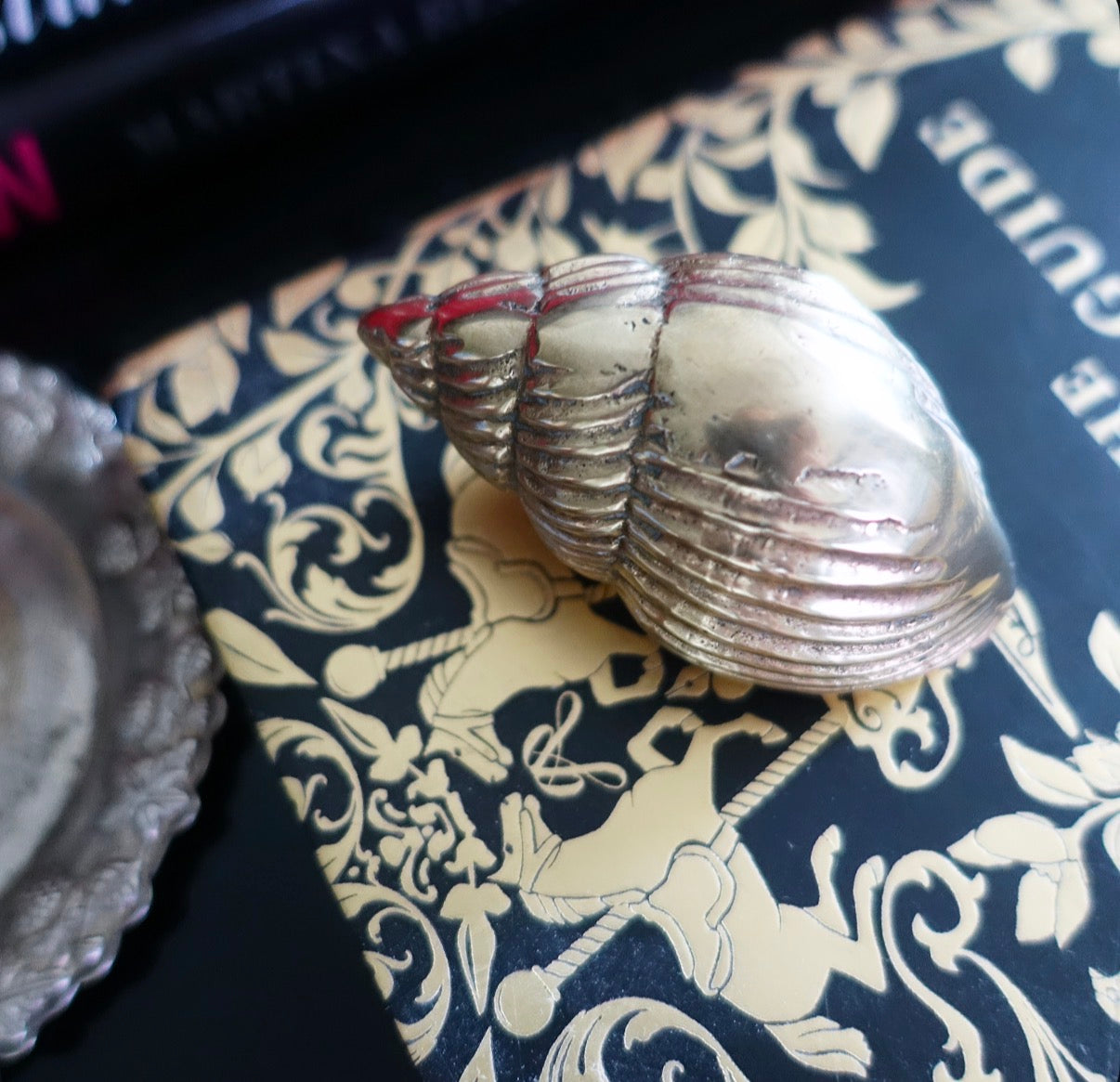 Small brass conch shell paperweight