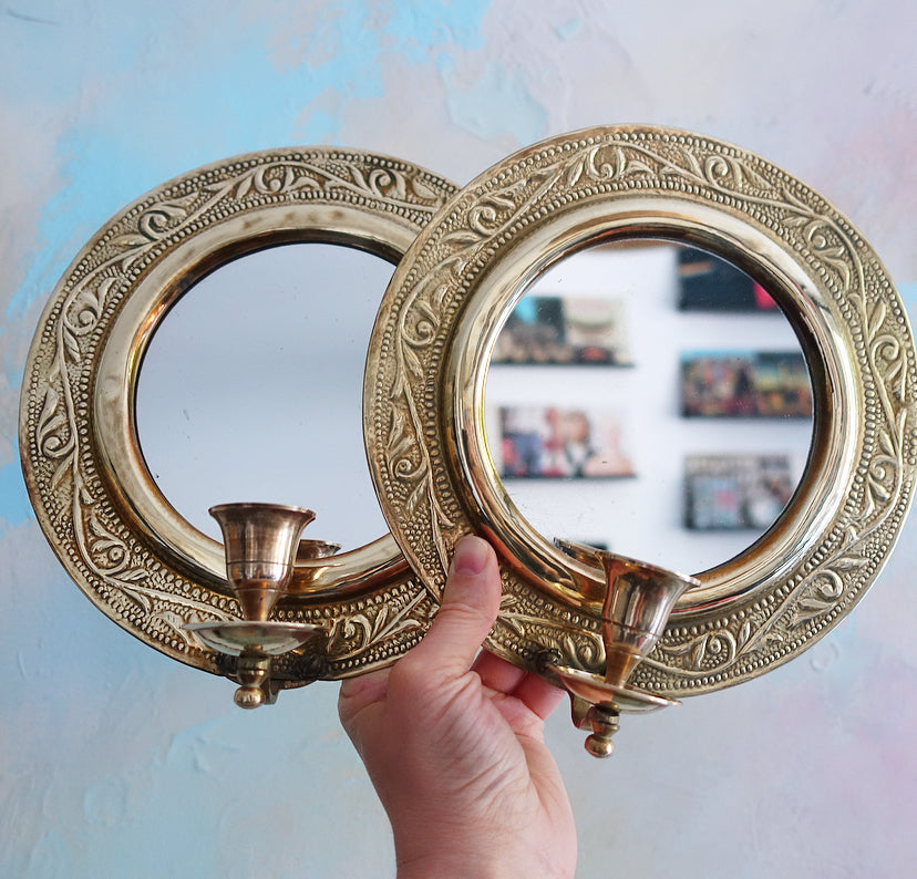 Pair of brass repoussé mirrored candle sconces