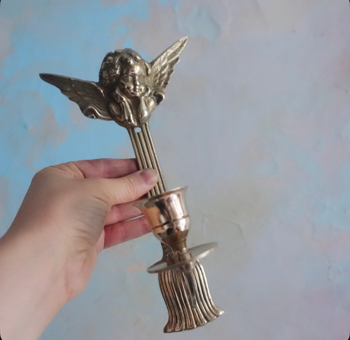 Pair of brass cherub candle sconces