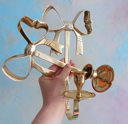 Pair of Hollywood Regency brass bow candle sconces