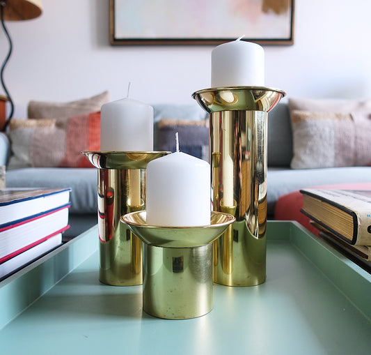 Set of three brass pillar candle holders