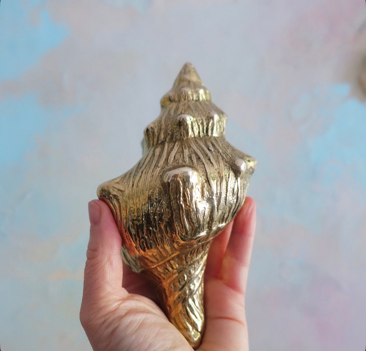 Brass conch shell paperweight
