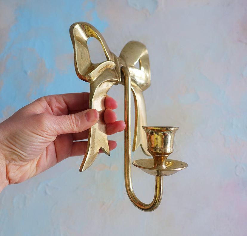 Pair of Hollywood Regency brass bow candle sconces