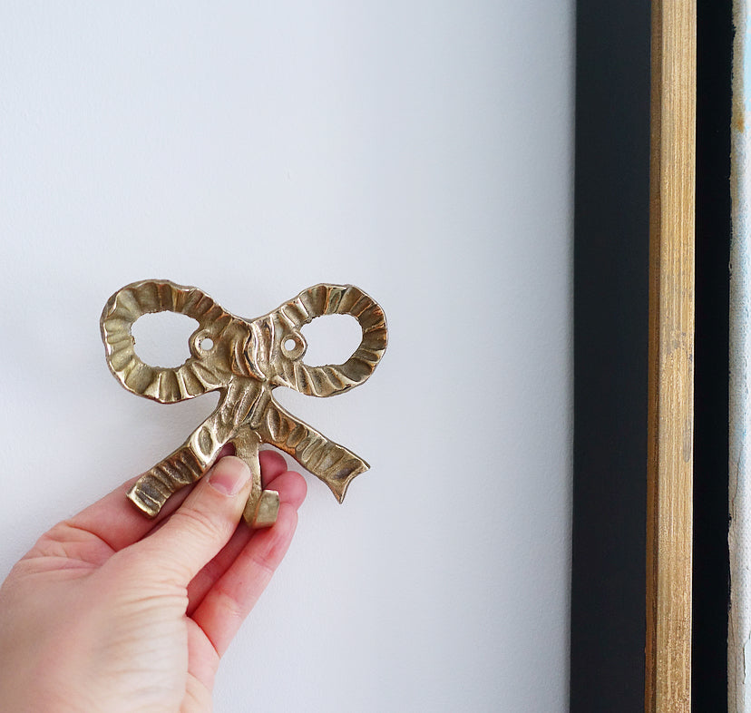 Set of three brass bow hooks