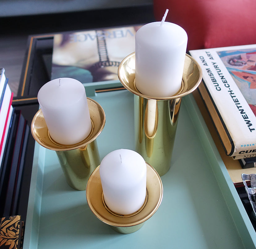 Set of three brass pillar candle holders