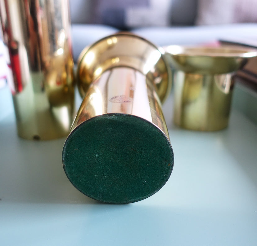 Set of three brass pillar candle holders