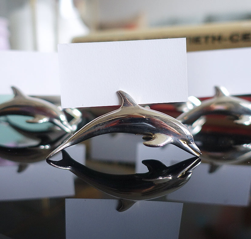 Set of six metal dolphin place card holders