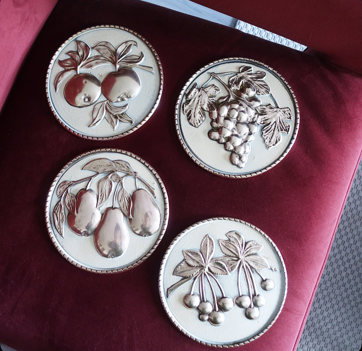 Set of four brass fruit wall plaques