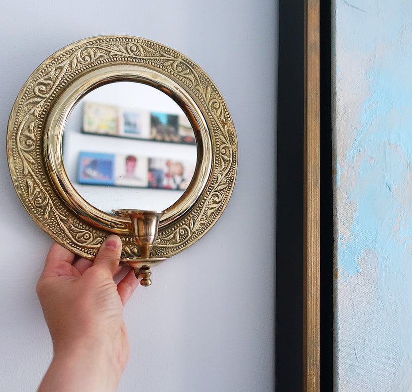 Pair of brass repoussé mirrored candle sconces