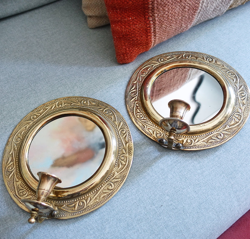 Pair of brass repoussé mirrored candle sconces