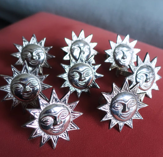 Set of eight sun napkin rings