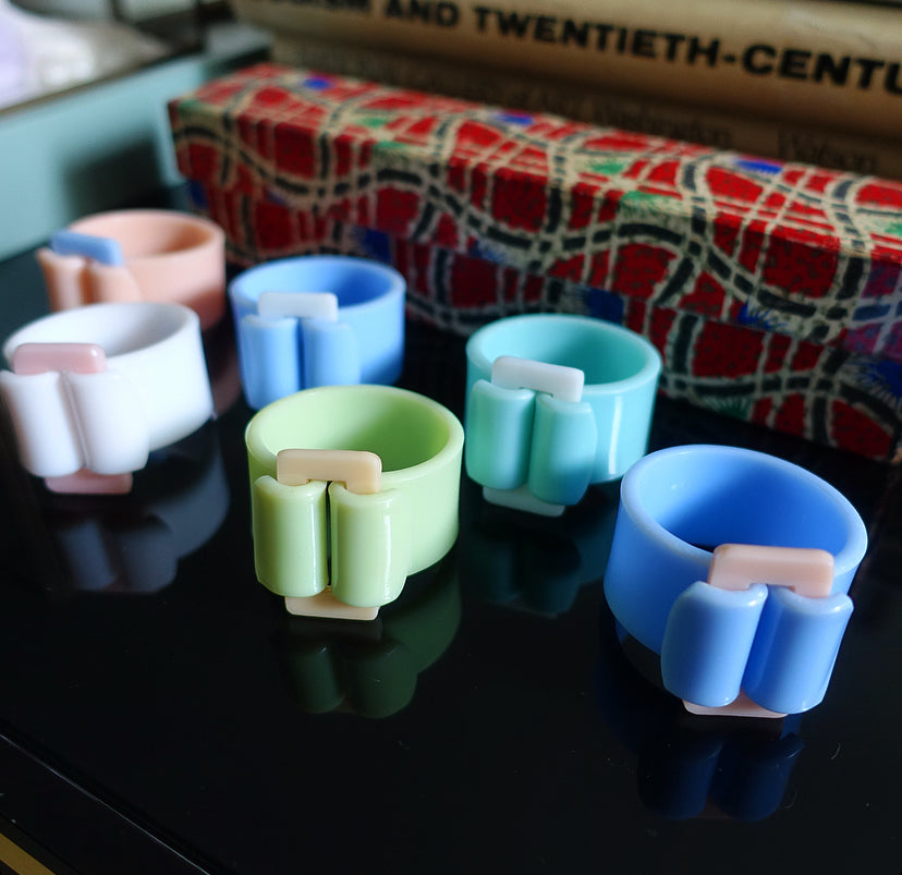 Rare set of six pastel Bakelite buckle napkin rings