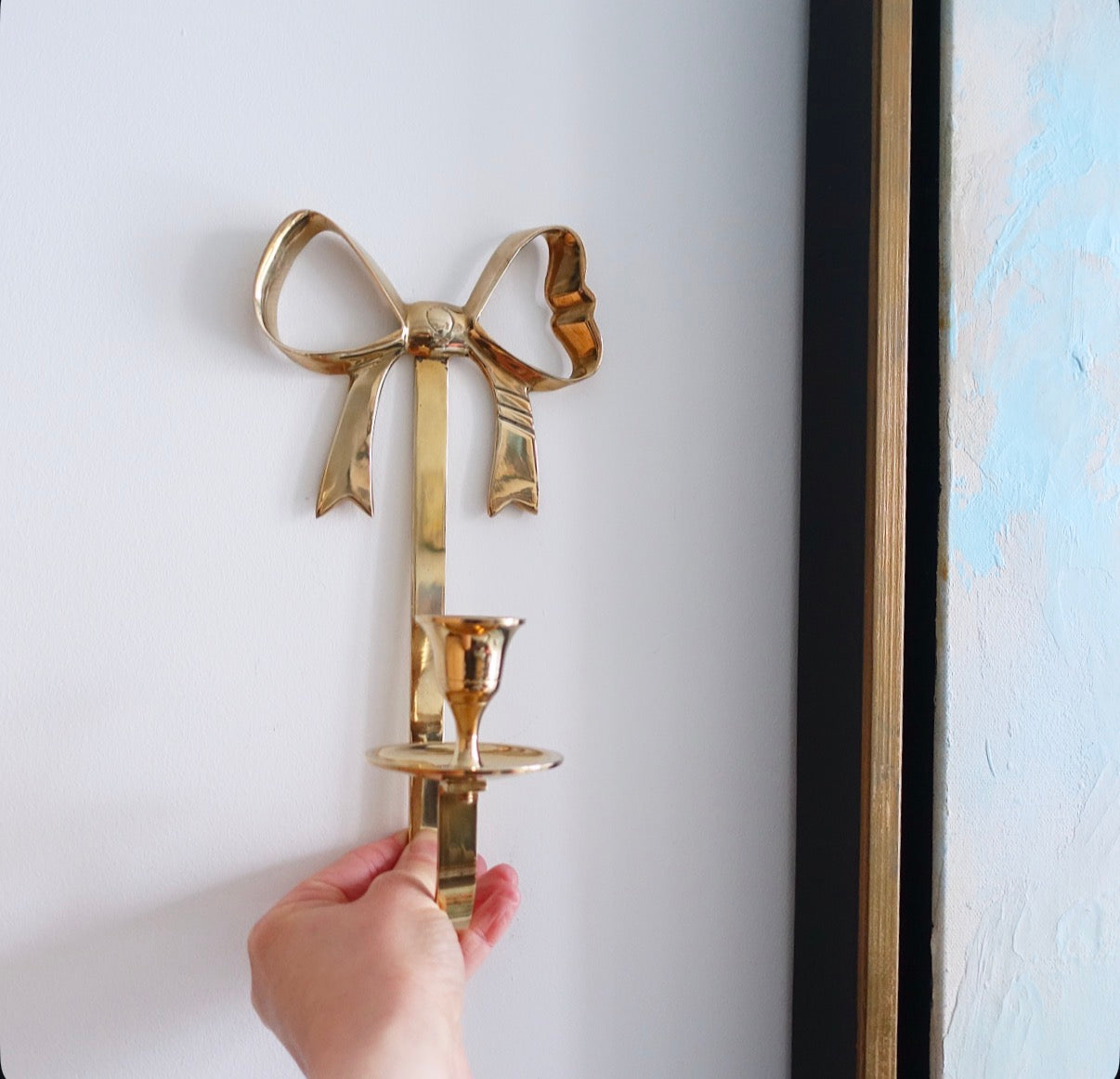 Brass bow candle sconces