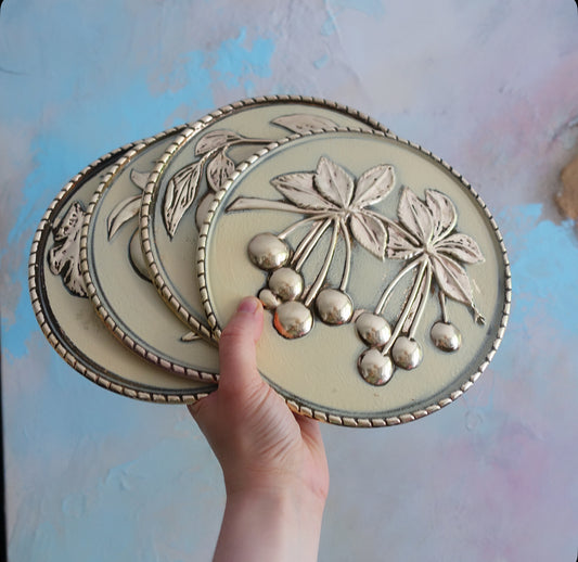 Set of four brass fruit wall plaques