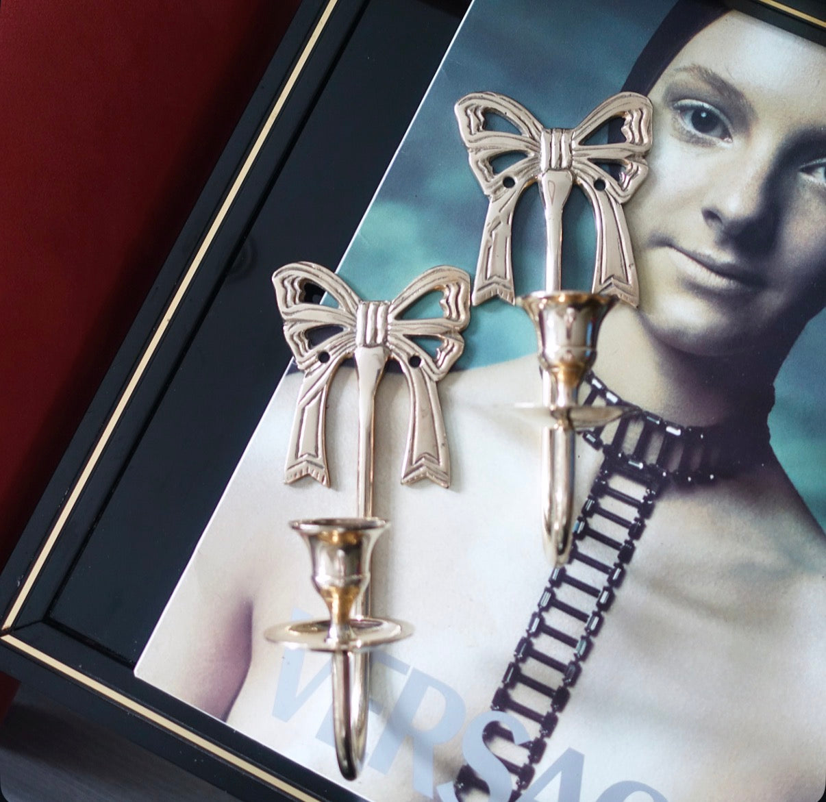 Pair of brass bow candle sconces