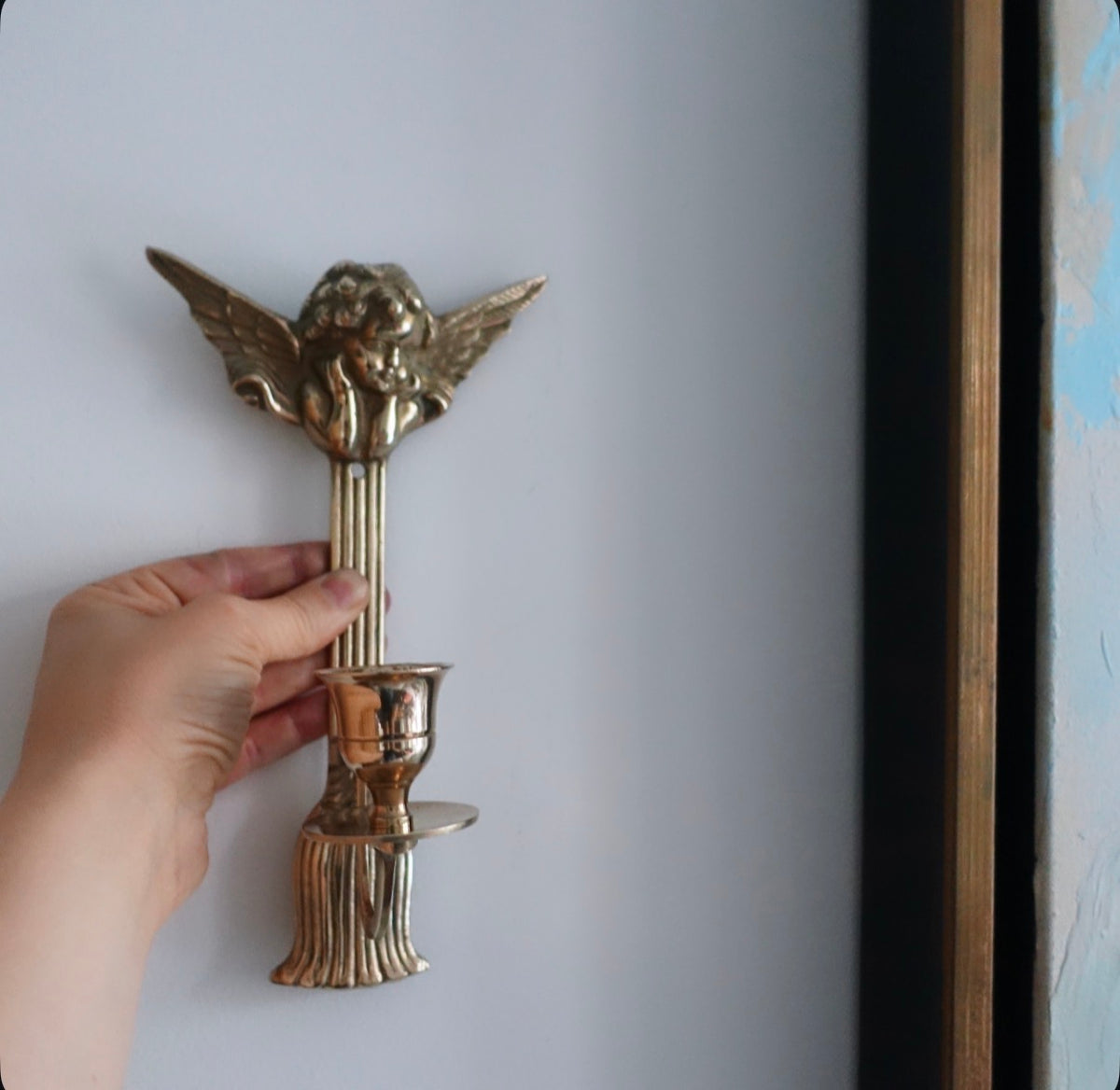 Pair of brass cherub candle sconces