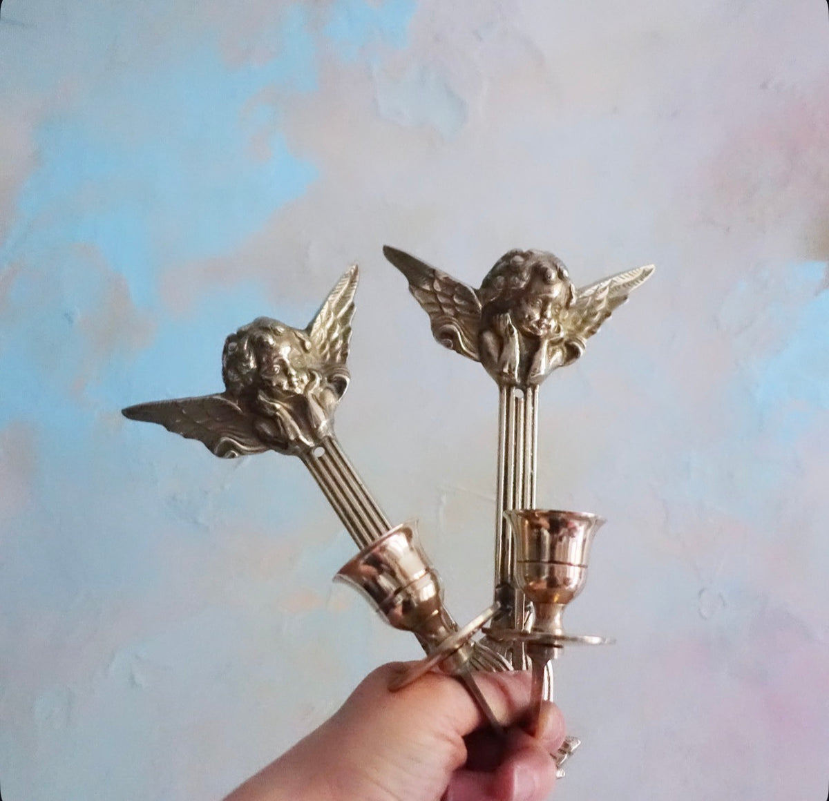 Pair of brass cherub candle sconces