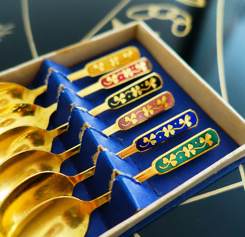 Set of six Danish gold plated and rainbow enamel lucky charm spoons