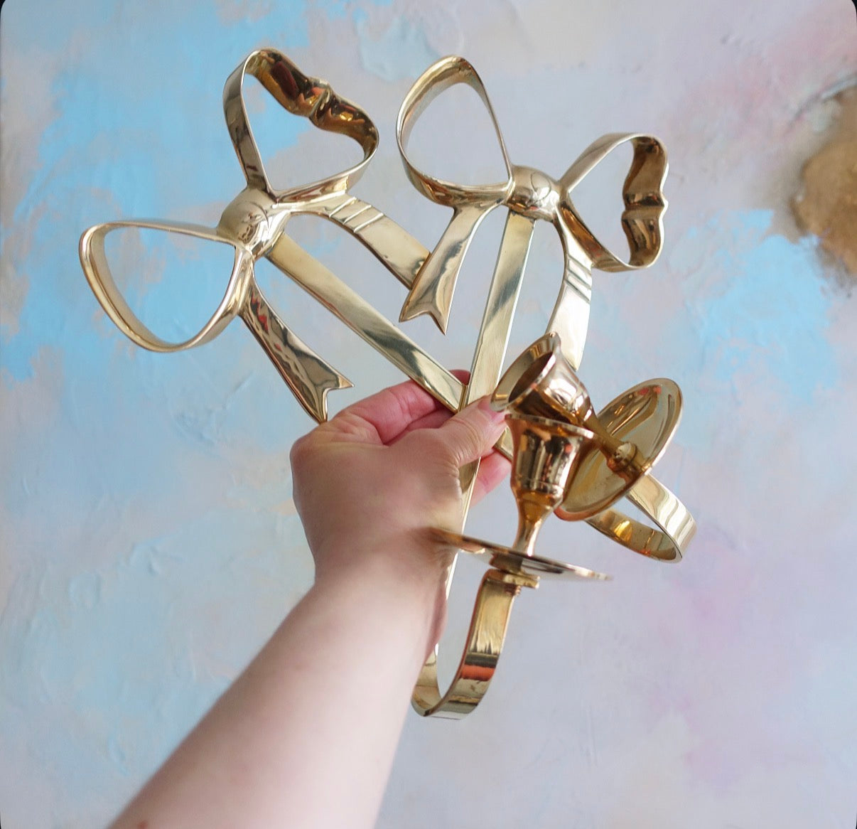 Brass bow candle sconces