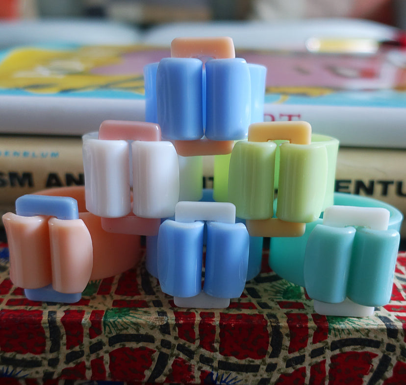 Rare set of six pastel Bakelite buckle napkin rings