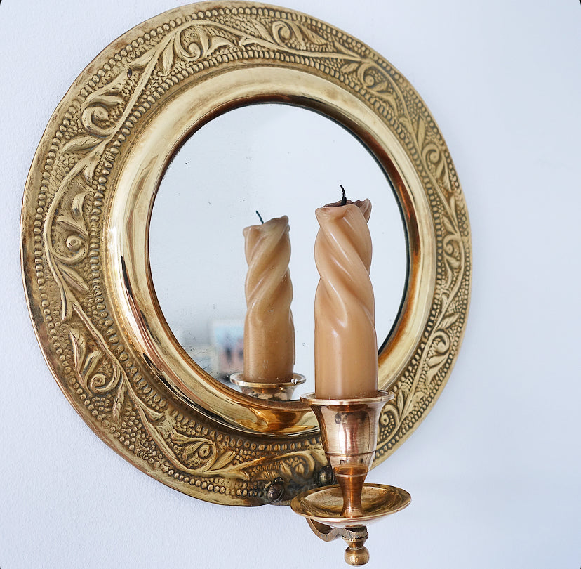 Pair of brass repoussé mirrored candle sconces