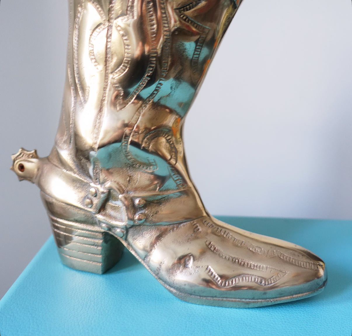 Large brass cowboy boot