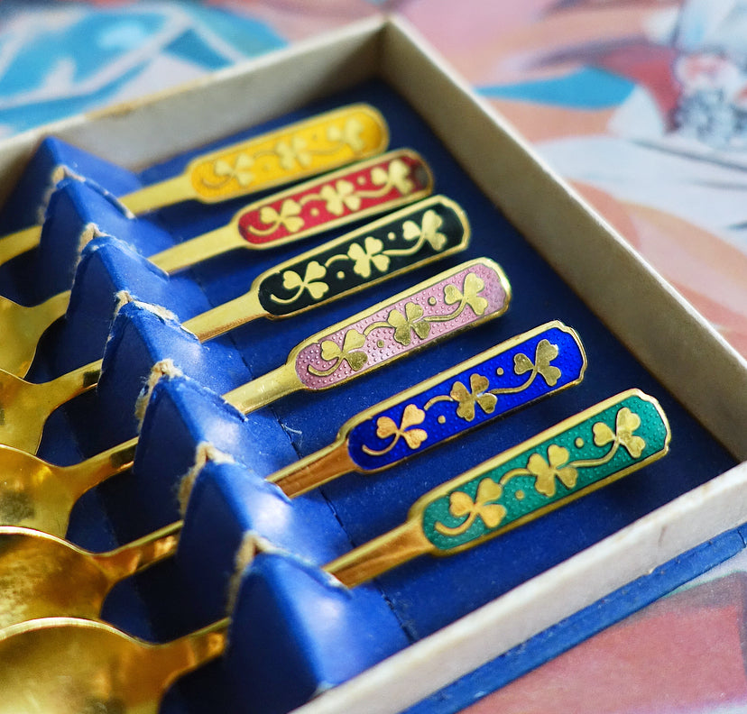 Set of six Danish gold plated and rainbow enamel lucky charm spoons