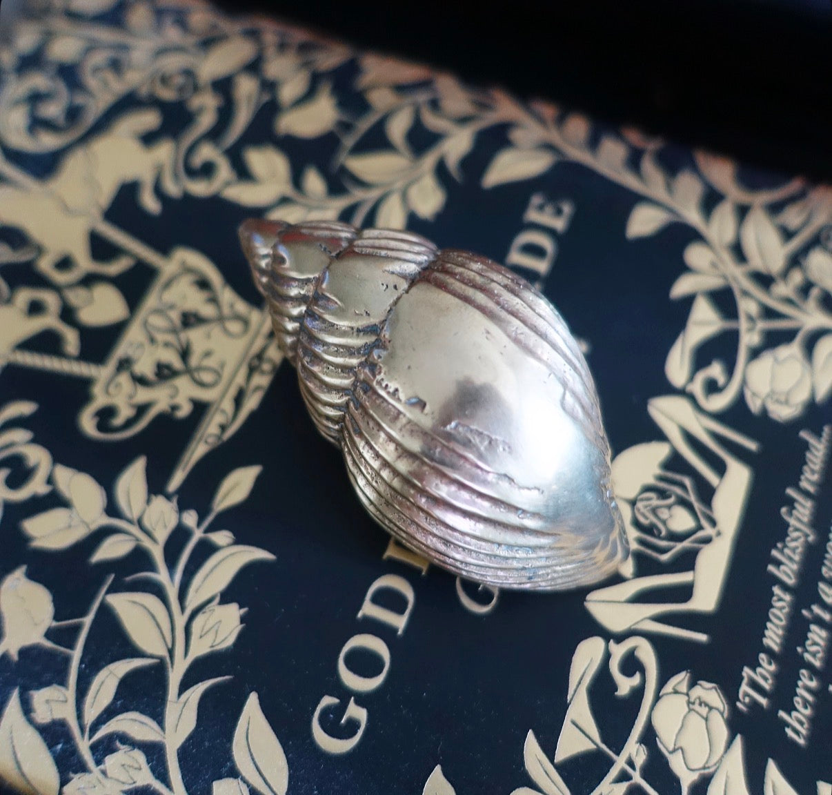 Small brass conch shell paperweight