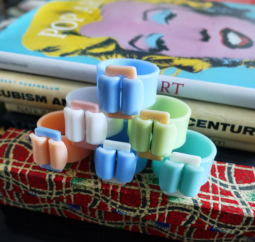 Rare set of six pastel Bakelite buckle napkin rings