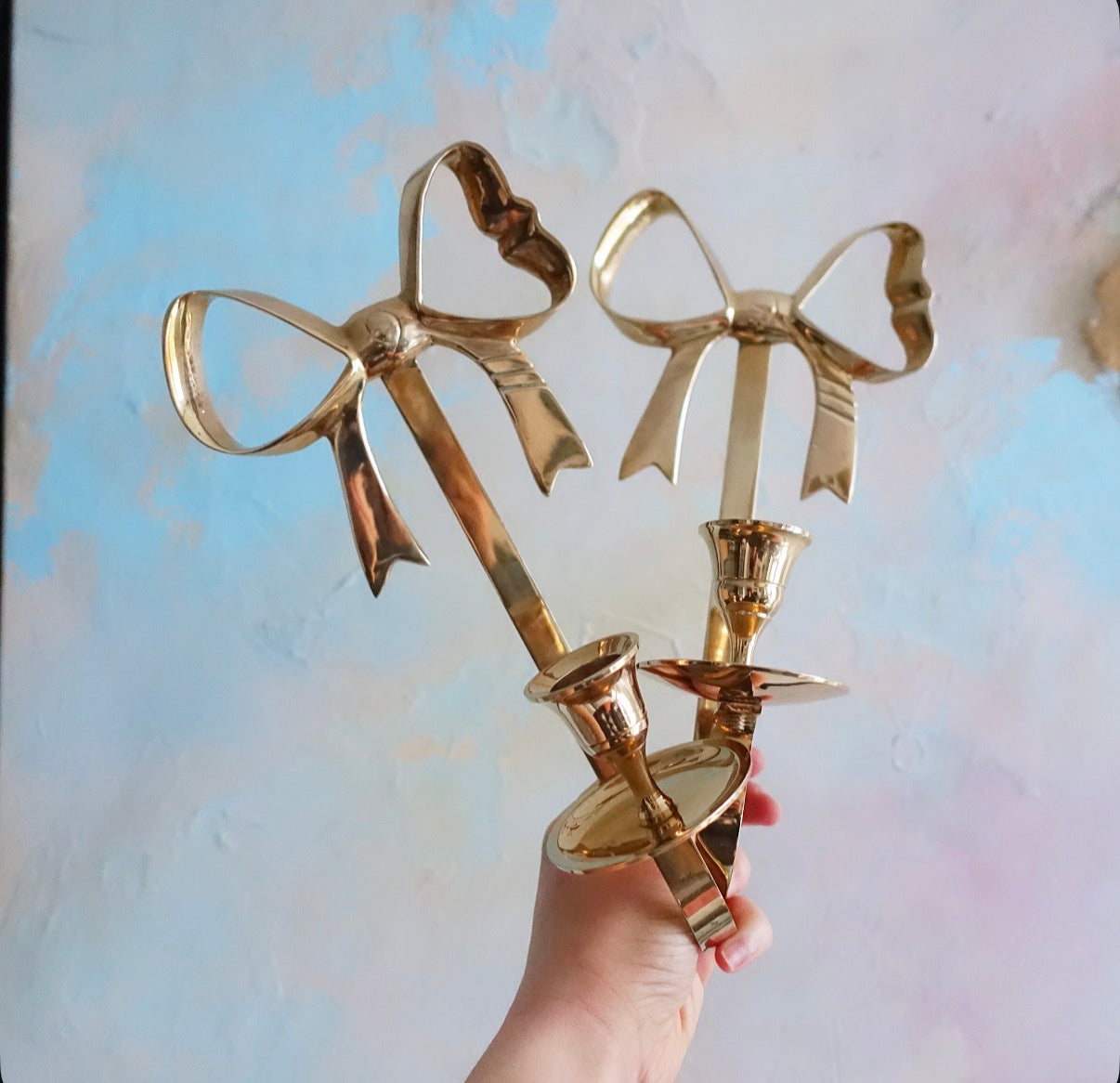 Brass bow candle sconces