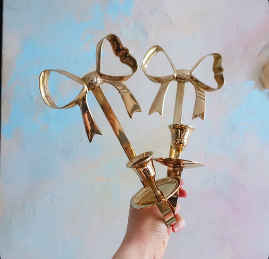 Brass bow candle sconces