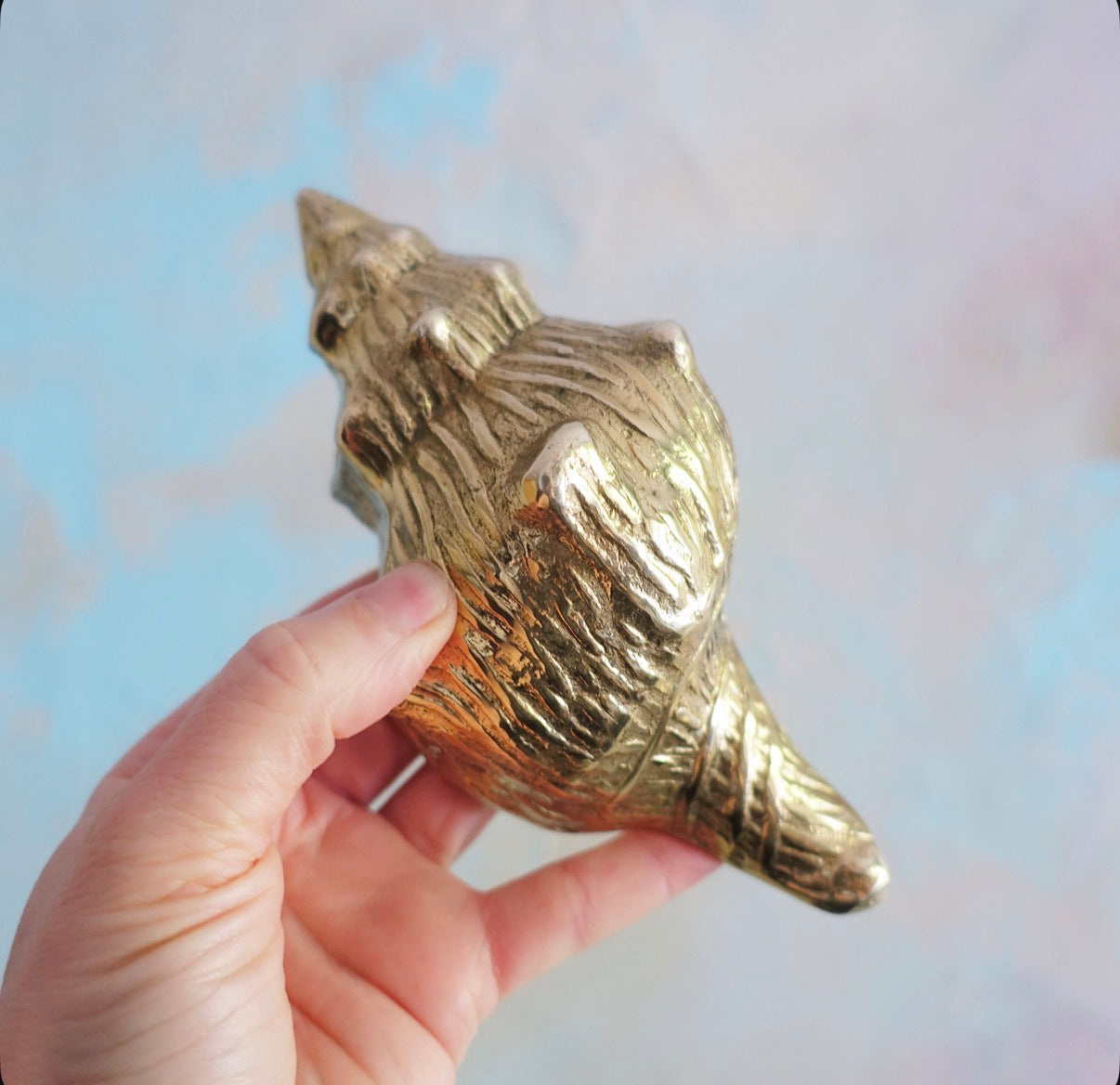 Brass conch shell paperweight